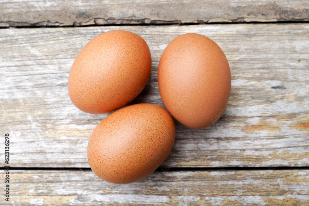 Farm fresh eggs isolated on wooden table. Farm fresh eggs isolated on wooden table.