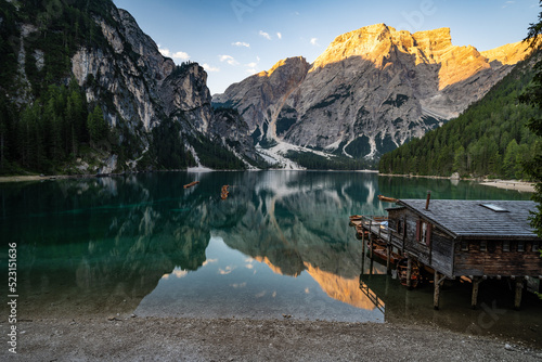 Panoramic view of Braies Lake with the hut and boats in Dolomites mountains and Seekofel in the morning. Braies Lake (Pragser Wildsee, Lago di Braies), Dolomites, South Tirol, Italy, Europe.
