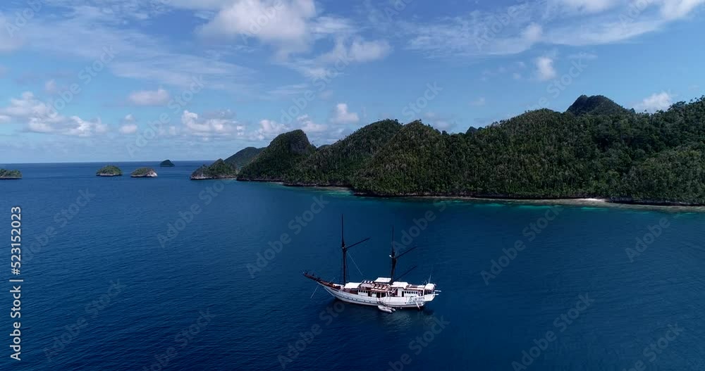 Aerial shot of diving boat near tropical islands with turquoise water Aerial shot of diving boat near tropical islands with turquoise water