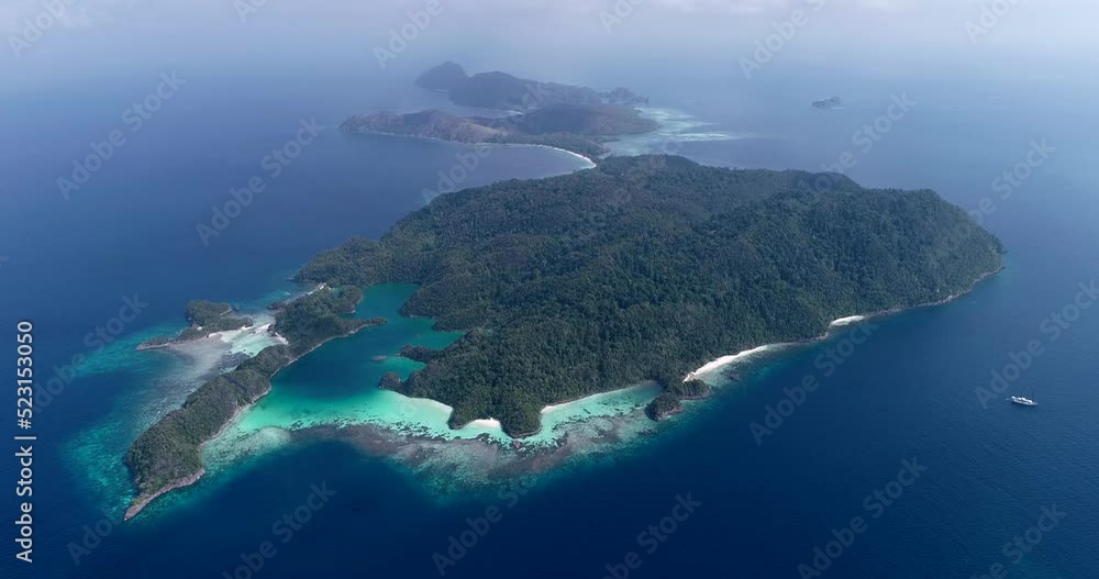 Aerial shot of diving boat near tropical island, turquoise water and beaches Aerial shot of diving boat near tropical island, turquoise water and beaches