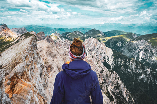 Young woman enjoys beautiful view from Seekofel on the Dolomite mountains at noon.Seekofel, Dolomites, South Tirol, Italy, Europe. © Michael