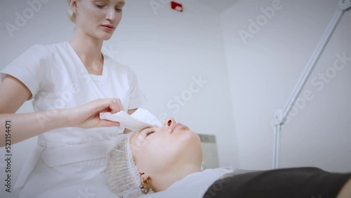 Wallpaper Mural Вeautician cosmetologist doing procedure fractional microneedle mesotherapy with Dermapen. Hardware cosmetology in clinic salon for client.  Torontodigital.ca