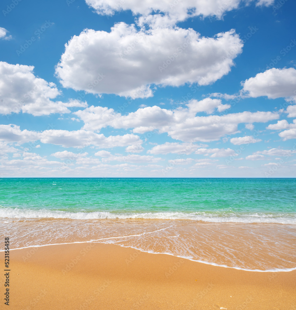 Obraz premium Sandy seashore at day.