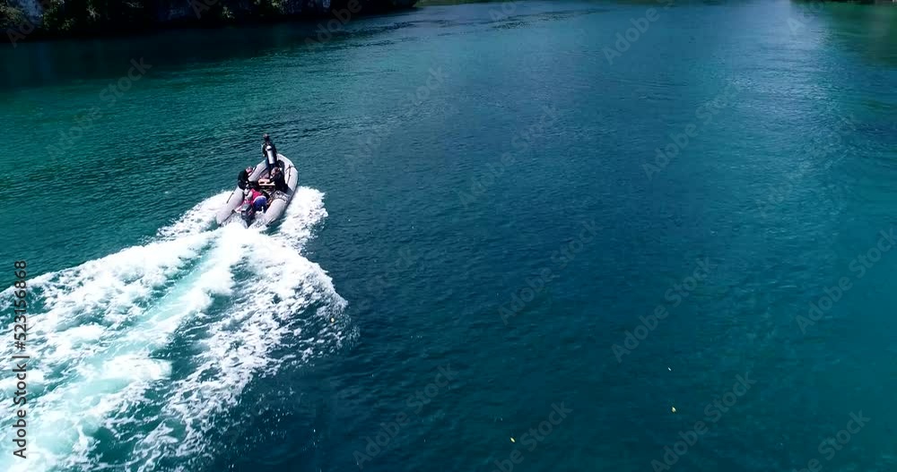 Aerial shot of zodiac boat with divers navigating away from its main boat Aerial shot of zodiac boat with divers navigating away from its main boat