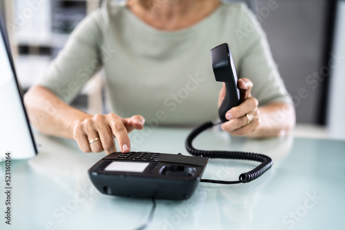 Businesswoman Hand Making Landline Telephone Call Pressing photo
