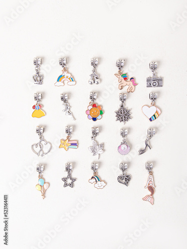Canvas-taulu Assorted metal charms for bracelets on white background