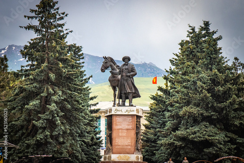 statue in karakol, tian shan mountains in background, kyrgyzstan, central asia