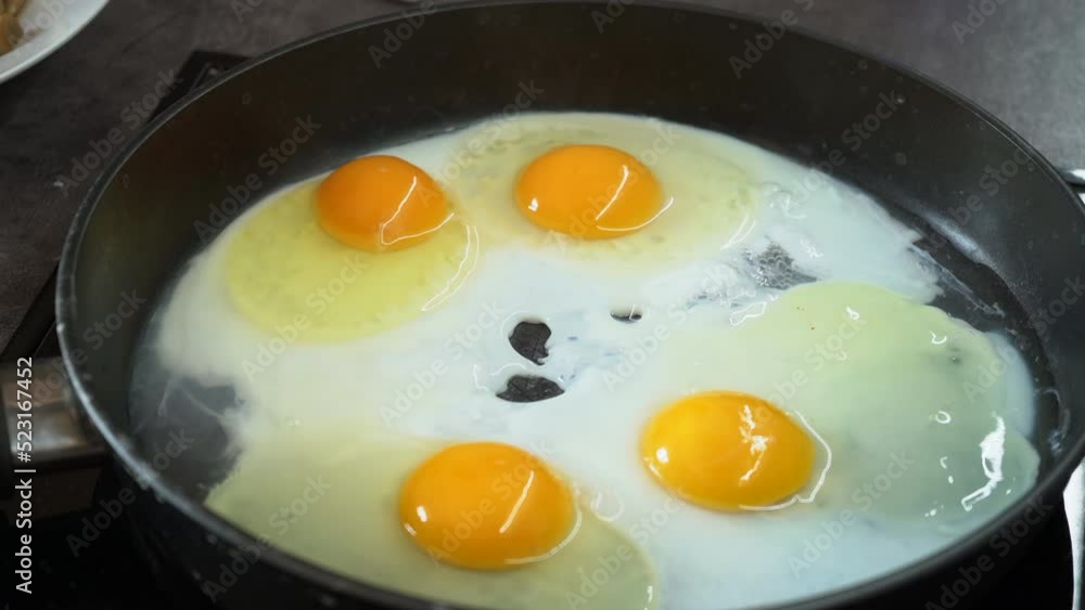 Cooking scrambled eggs on skillet. Woman stirring eggs on skillet to prepare scrambled eggs for breakfast. Cooking process. High quality 4k footage. Cooking scrambled eggs on skillet. Woman stirring eggs on skillet to prepare scrambled eggs for breakfast. Cooking process. High quality 4k footage.