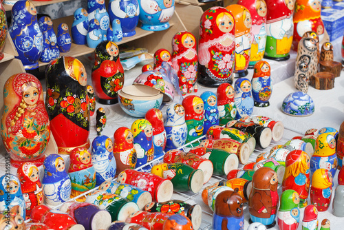 a variety of bright wooden toys, traditional nesting dolls on the counter.
