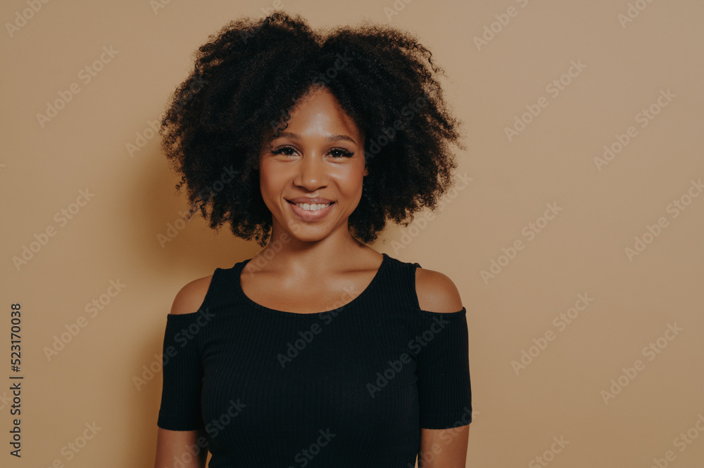 Portrait of cheerful smiling beautiful dark-skinned girl in black tshirt Portrait of cheerful smiling beautiful dark-skinned girl in black tshirt