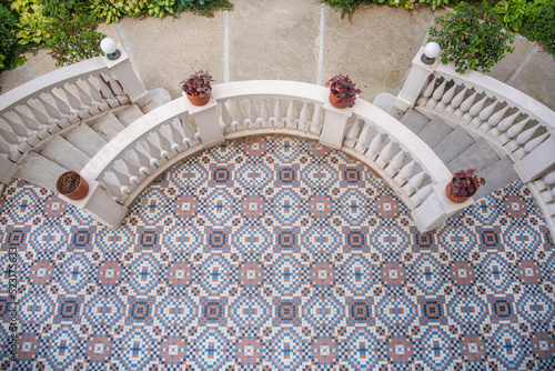 Small checkered square mosaic vintage tile on terrace floor. Residential exterior. Floor pattern tile texture background.