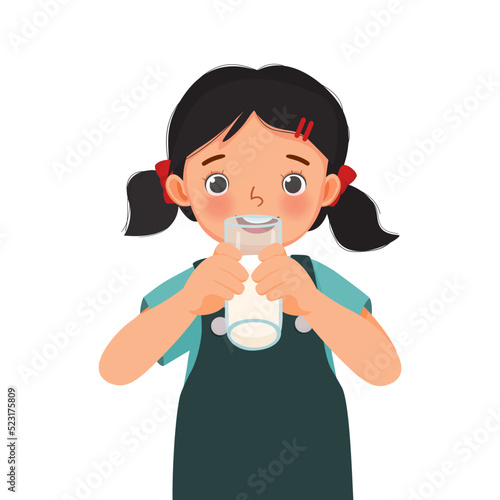 cute little girl drinking a glass of milk