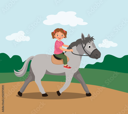cute little girl riding a horse at the park