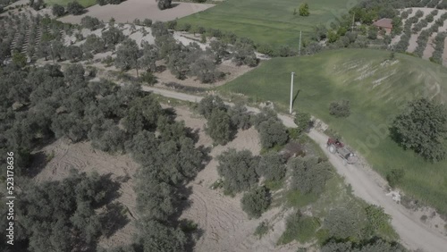 Aerial Drone view of Green Fields, Hills and Trees in a with Small Houses. Turkey.