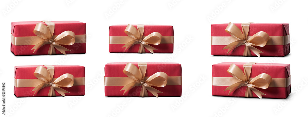 Top view of Christmas presents wrapped in red paper with gold ribbon and bow decoration isolated against a transparent background.