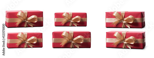 Top view of Christmas presents wrapped in red paper with gold ribbon and bow decoration isolated against a transparent background.