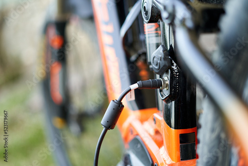 Close up of an e-bike plugged in charging