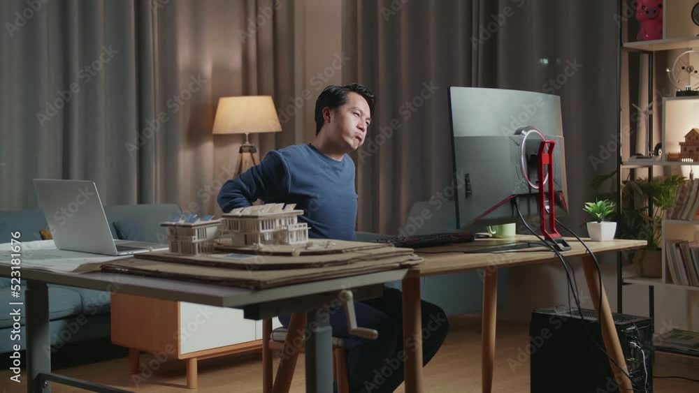 Asian Male Engineer With The House Model Stretching After Working On A Desktop At Home
Asian Male Engineer With The House Model Stretching After Working On A Desktop At Home