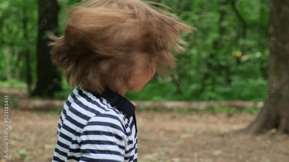 Little boy shakes his head in different directions and rubs his hair Slow motion Little boy shakes his head in different directions and rubs his hair Slow motion