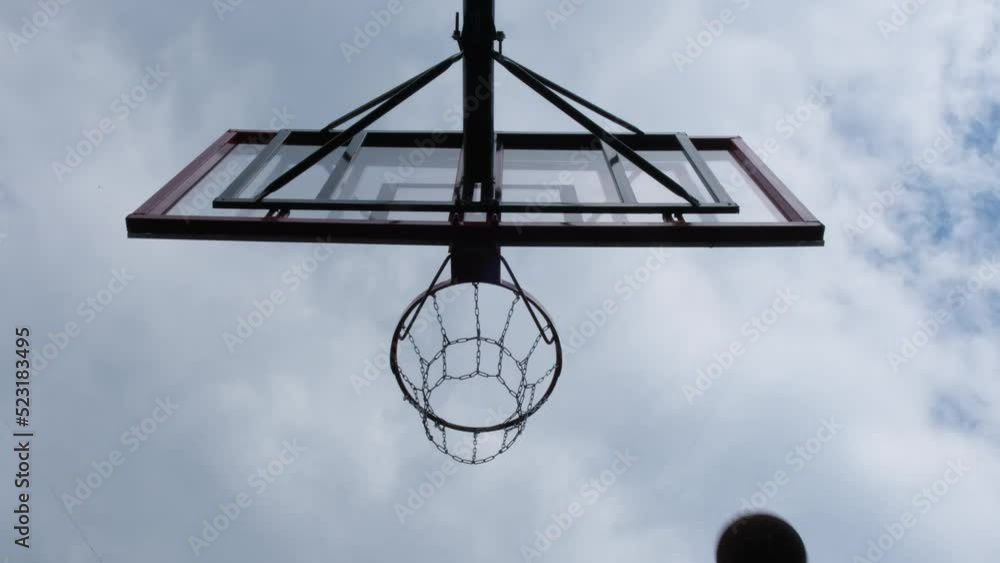 Basketball flies into basket and bounces ricochet past. Closeup cinematic shot Basketball flies into basket and bounces ricochet past. Closeup cinematic shot