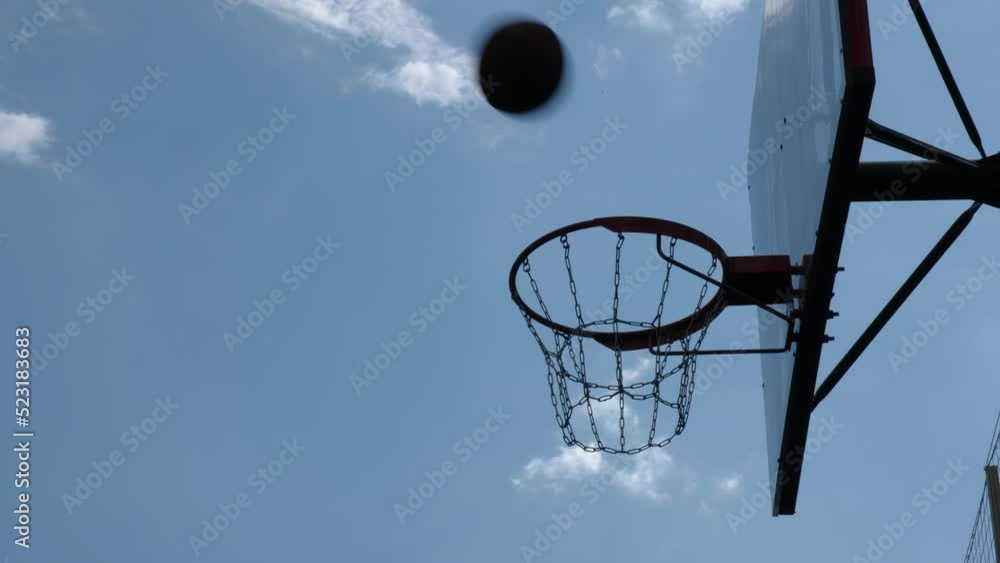 Basketball flies past basket in street game. Closeup cinematic shot Basketball flies past basket in street game. Closeup cinematic shot
