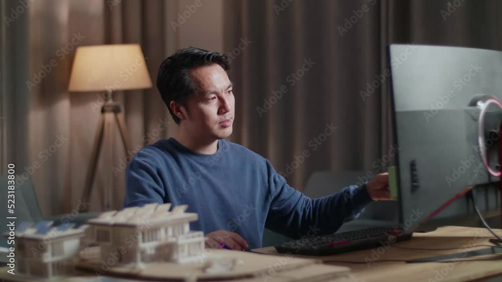 Asian Male Engineer With The House Model Drinking Coffee While Working On A Desktop At Home
Asian Male Engineer With The House Model Drinking Coffee While Working On A Desktop At Home
