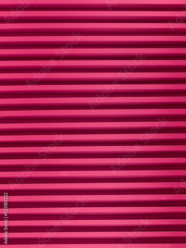 Background of pink horizontal metal strips.