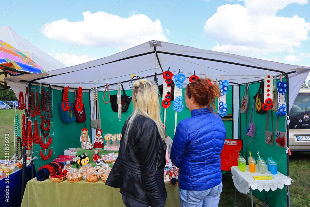 Girls choose jewelry at a crafts fair in Ukraine