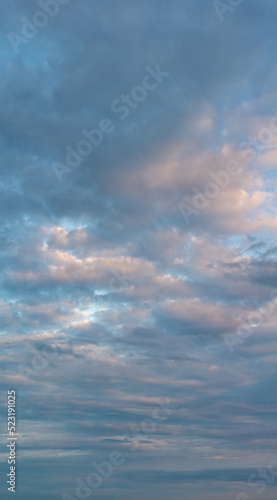 Fantastic clouds at sunrise, vertical panorama © StepStock