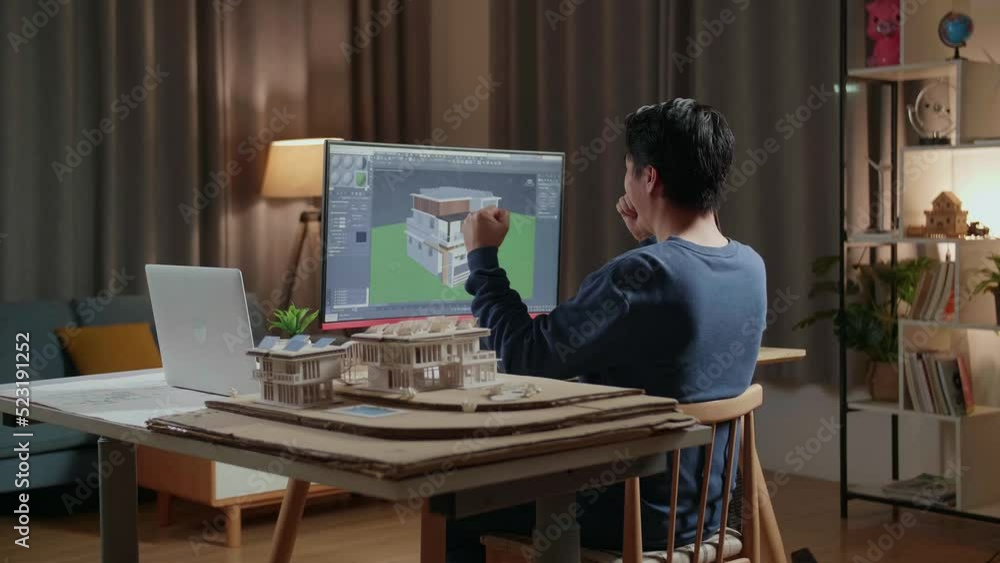 Asian Male Engineer Celebrating While Designing House On A Desktop At ...