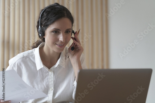 Young italian woman call center agent in headset talking with client, consulting customer online