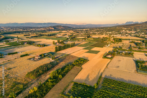 Panorama of the farmland and the mountain range during the sunset of Loriol Sur Drome - Drome - France photo