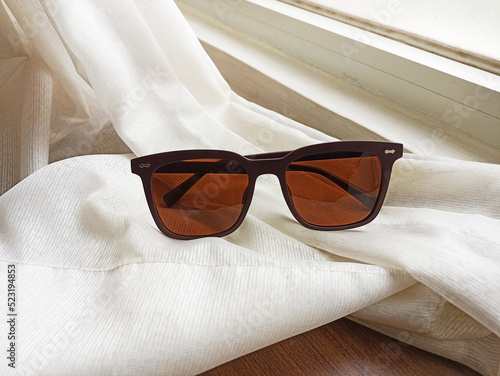 Brown polarized sunglasses on the bed