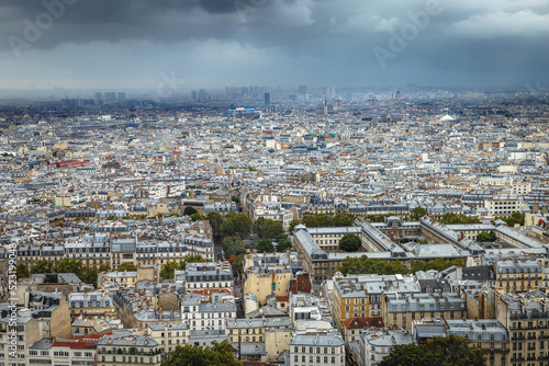 Above Paris from Sacre Couer tower in Montmartre with dramatic sky, France