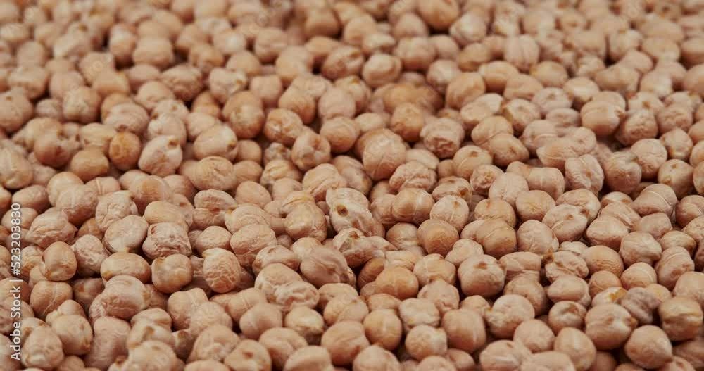 Food Background From the Texture of Raw Chickpeas Close-up Rotating, Selective Focus Food Background From the Texture of Raw Chickpeas Close-up Rotating, Selective Focus
