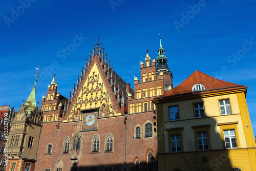 old town hall building with a clock in the center on Wroclaw Square Poland