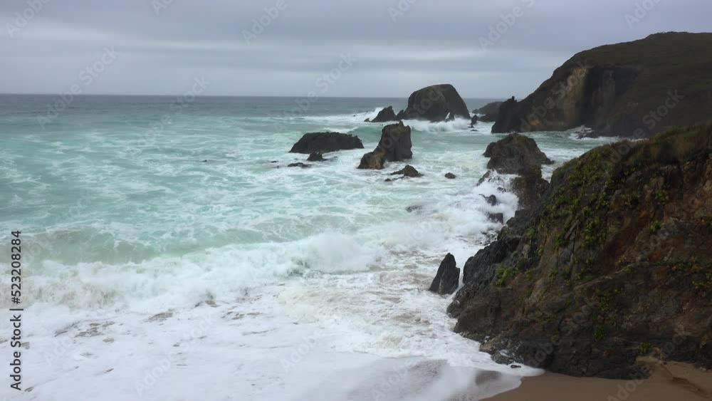 Raging sea with waves beating rock islands on the coast Raging sea with waves beating rock islands on the coast