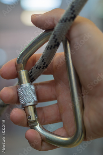 Steel carabiner and rope in hand