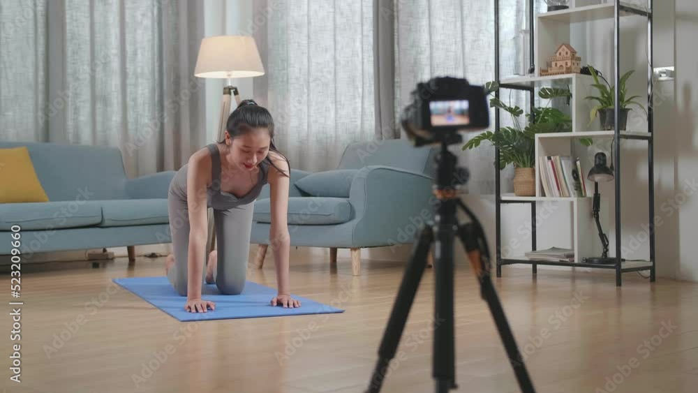 Full View Of Young Asian Trainer Female In Sports Clothes Speaking To Camera And Doing Yoga In Balancing Table Pose While Recording Teaching Exercise At Home
Full View Of Young Asian Trainer Female In Sports Clothes Speaking To Camera And Doing Yoga In Balancing Table Pose While Recording Teaching Exercise At Home