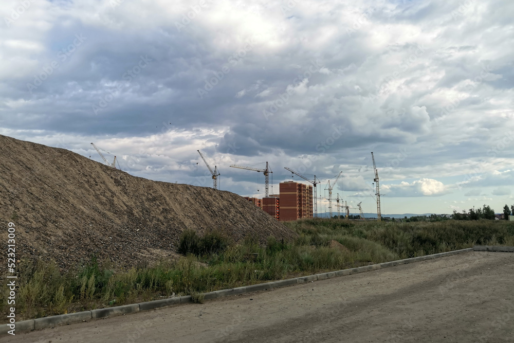 Obraz premium view of construction site and tower crane