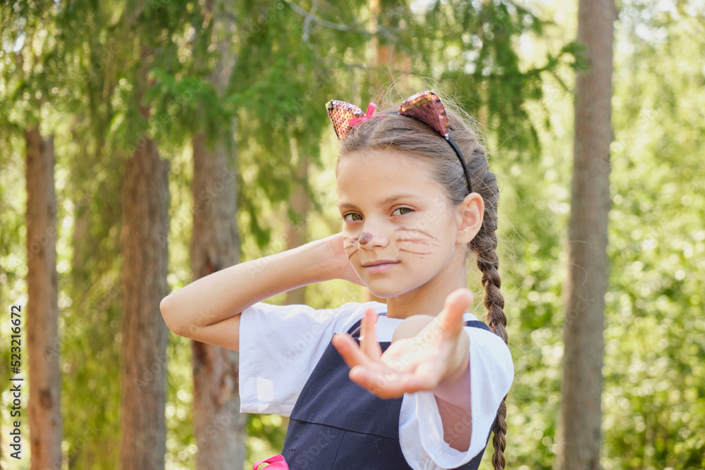 cheerful teenage girl in a costume for the celebration of halloween, a costume party in nature cheerful teenage girl in a costume for the celebration of halloween, a costume party in nature