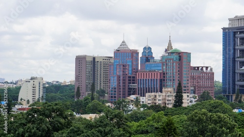Bangalore,Karnataka,India-June 19 2022: View of Bangalore cityscape from terrace of Chancery Pavilion Hotel. Stadium and skyscrapers such as Prestige UB City Concorde Block visible through green cover photo