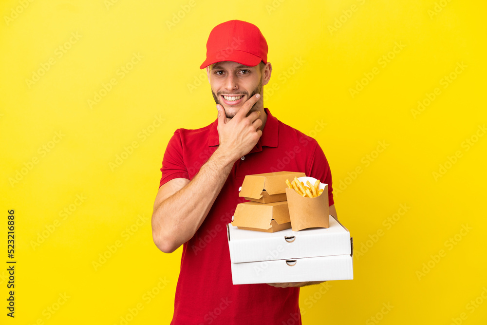 pizza delivery man picking up pizza boxes and burgers over isolated background happy and smiling pizza delivery man picking up pizza boxes and burgers over isolated background happy and smiling