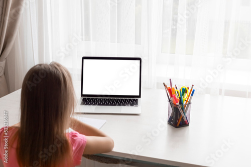 school at home through online homeschooling. the child is sitting at the computer