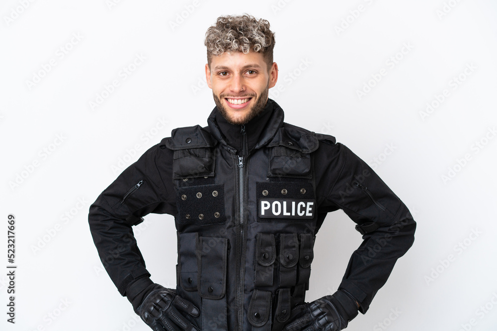 SWAT caucasian man isolated on white background posing with arms at hip and smiling SWAT caucasian man isolated on white background posing with arms at hip and smiling