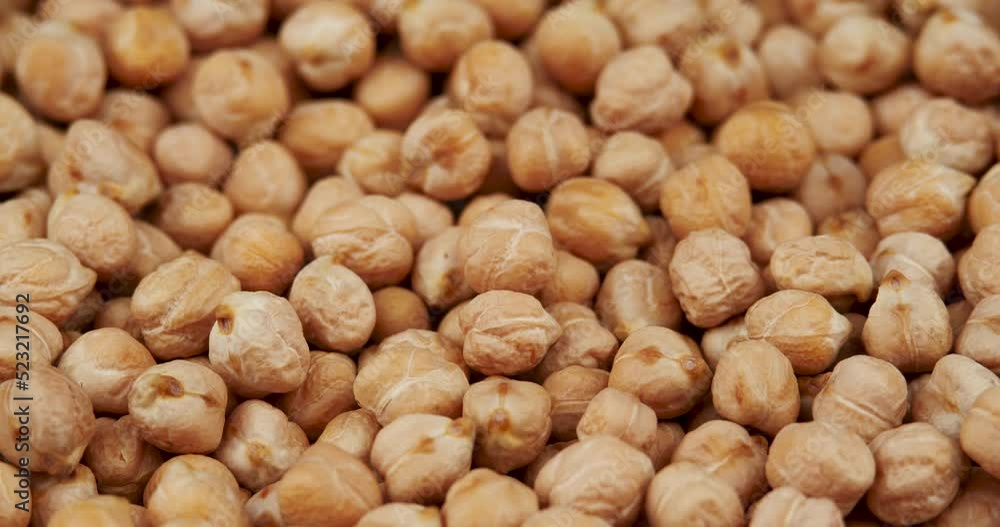 Food Background From the Texture of Raw Chickpeas Close-up Rotating, Selective Focus Food Background From the Texture of Raw Chickpeas Close-up Rotating, Selective Focus