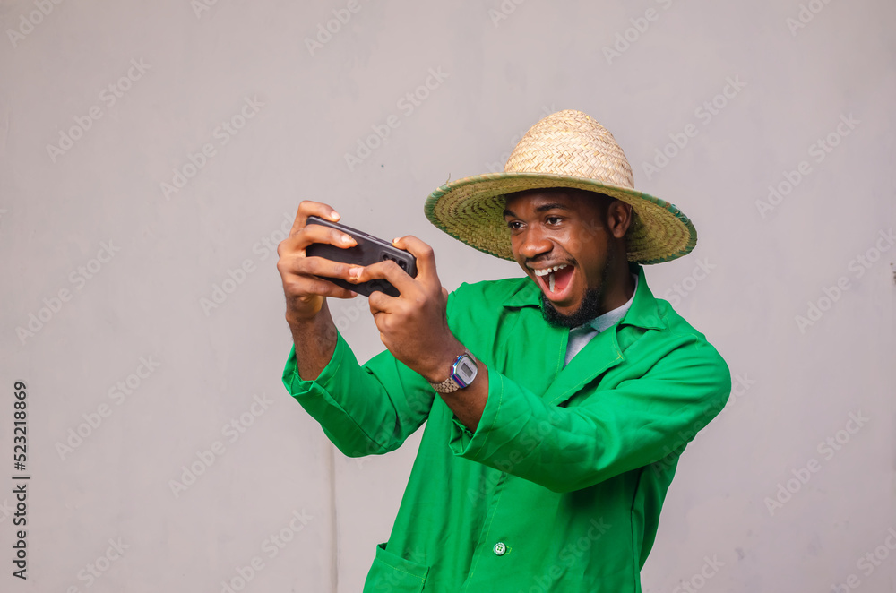 Cheerful African American man in white shirt using mobile phone application.