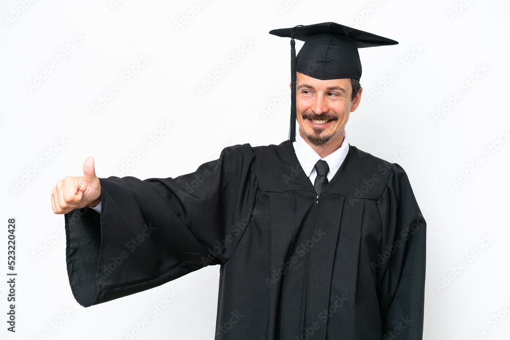 Young university graduate man isolated on white background giving a thumbs up gesture Young university graduate man isolated on white background giving a thumbs up gesture