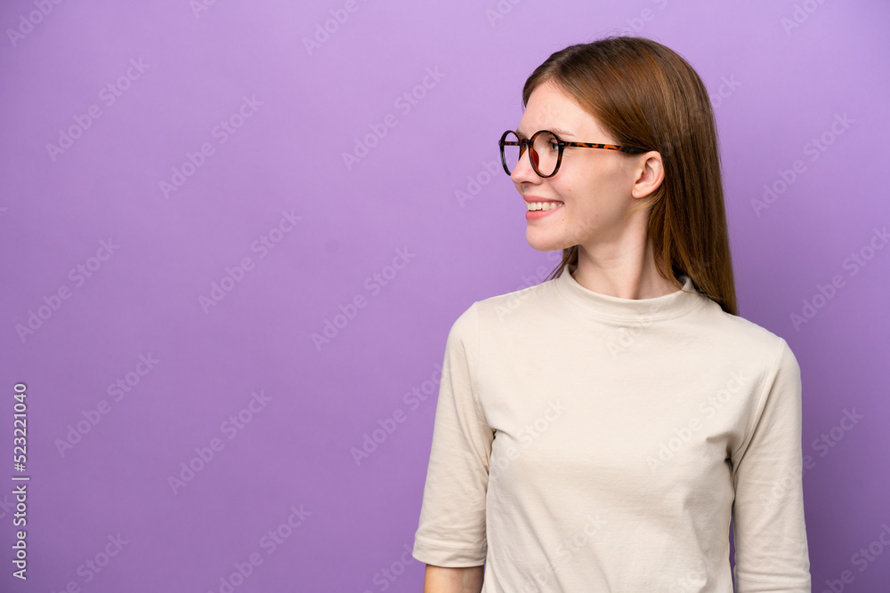 Young English woman isolated on purple background looking side Young English woman isolated on purple background looking side