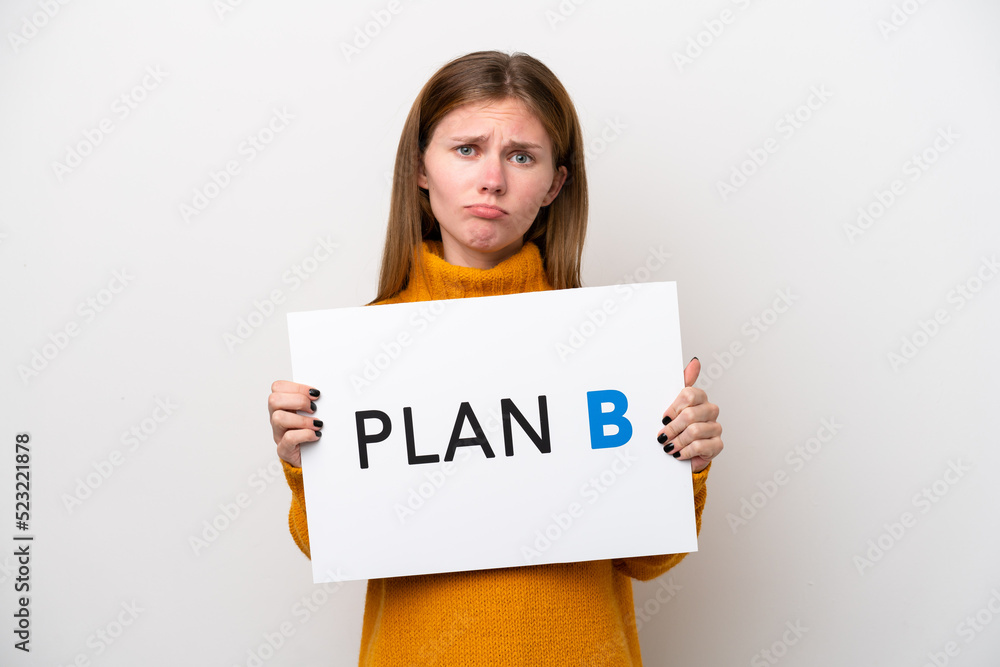Young English woman isolated on white background holding a placard with the message PLAN B with sad expression Young English woman isolated on white background holding a placard with the message PLAN B with sad expression